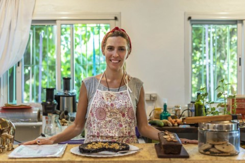 Business owner standing at the bar of her coffee and juice shop. Entrepreneur concept. Successful woman feeling confident
