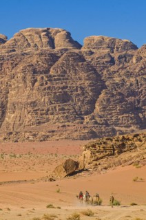Bedouins with camels in desert