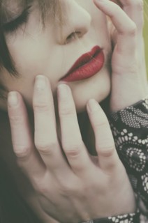 Beautiful young woman hands touching face