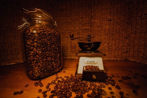 Jar with coffee beans on the wooden table