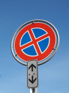 No parking and no stopping sign over blue sky