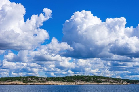 Archipelago and coastline under a wildly cloudy blue sky in the Kosterfjord between the Koster Islands and Stroemstad