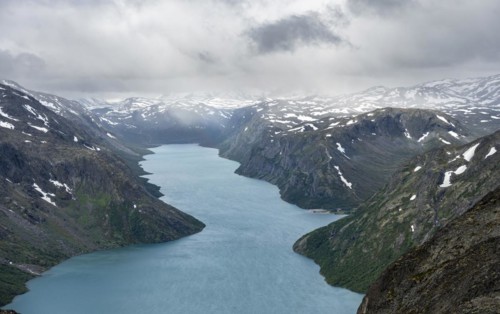 View of Lake Gjende and snowy mountains