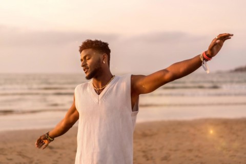 Portrait of black ethnic model enjoying summer vacation by the sea feeling free