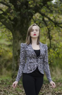 Beautiful young woman standing in the countryside