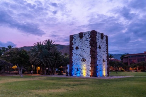 Beautiful park with the Torre del Conde illuminated at night in San Sebastian de La Gomera