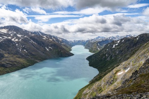 View of Lake Gjende and snowy mountains