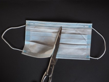 Proper disposal of used medical mask cut to prevent reuse