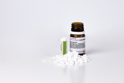 Homeopathic remedies lie in front of containers