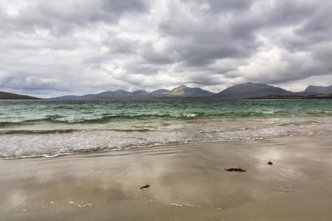 Coastline with sandy beach and mountains
