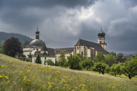 Thunderclouds pass over the Muenstertal and the monastery of Sankt Trudpert