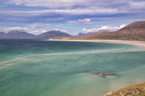 Coastline with sandy beach and mountains