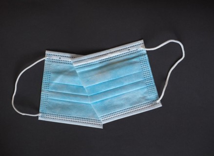Proper disposal of used medical mask cut to prevent reuse