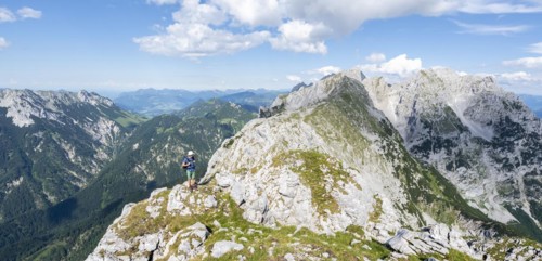 Mountaineer on a narrow ridge path