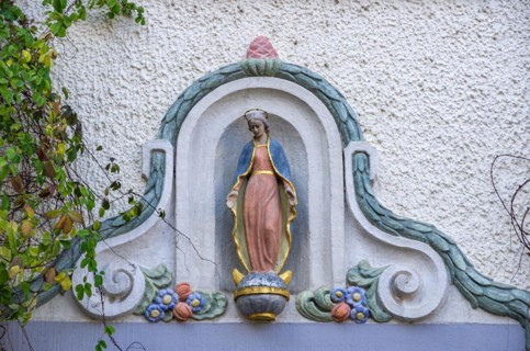 Madonna figure on a historical building in the old town