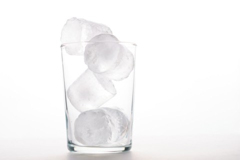 Close-up of an empty glass with ice isolated on a white background