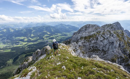 Mountaineer on a narrow ridge path