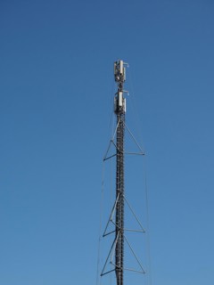 Aerial antenna tower over blue sky