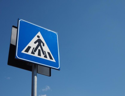 Zebra crossing sign over blue sky