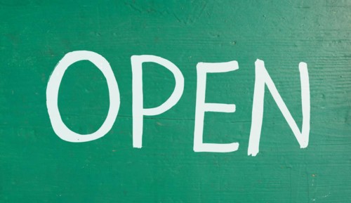 Handwritten open sign label tag on a store front