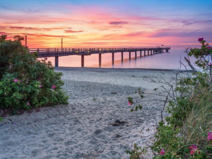 Pier on the beach of the Baltic Sea at sunset
