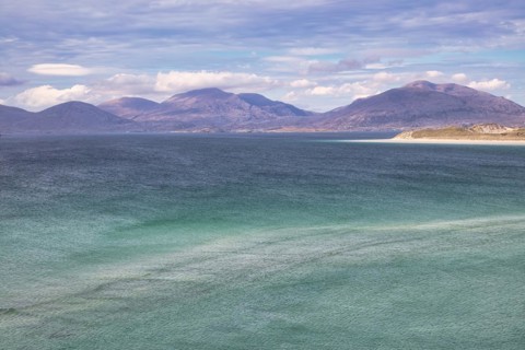 Coastline with sandy beach and mountains