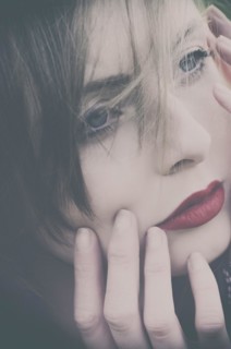 Beautiful young woman hands touching face looking away