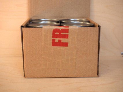 Fragile cardboard box with tin cans