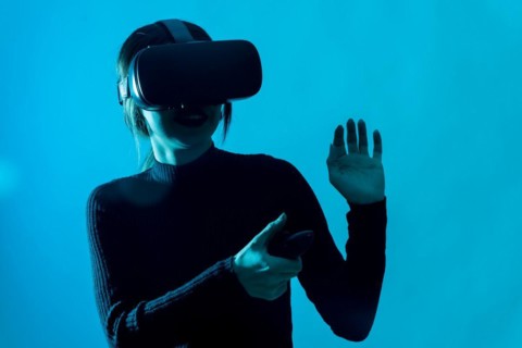 Metaverse technology concept. Woman with virtual reality VR glasses. Futuristic lifestyle