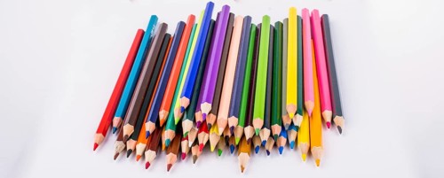 Color pencils and back to school title on a notebook