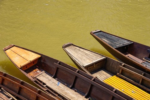 Tips of wooden barges in the water