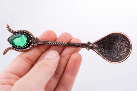 Hand holding a Retro styled teaspoon