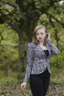 Sad young woman standing in the countryside