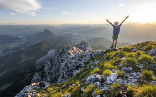 Mountaineer stretching his arms in the air
