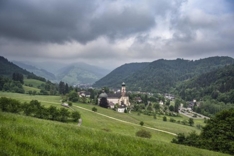Thunderclouds pass over the Muenstertal and the monastery of Sankt Trudpert