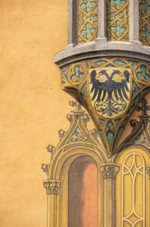 Bay window with fresco of a coat of arms with double-headed eagle on the south-east corner of the historic