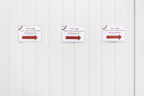 Three notices with the inscription 'Patients with cough
