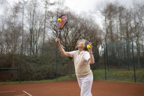 Subject: Woman aged 83 standing on the tennis court.