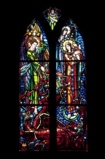 Stained-glass window picturing Saint Michael fighting dragon