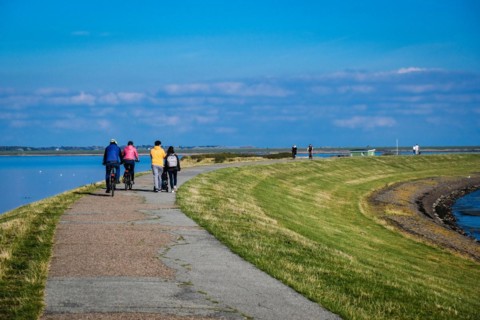 Pedestrians on the dyke of the Rantum basin on Sylt