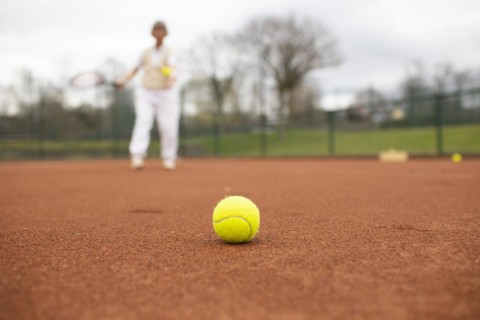 Subject: Woman aged 82 standing on the tennis court