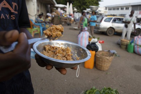 Man with a plate of food at a market