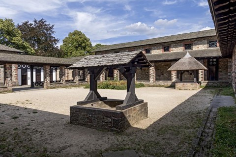 Well house with wooden roof and thatched roof