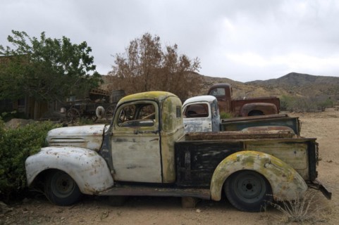 Old vintage pickup trucks along the Route 66 at the general store of the ghost town Hackberry in Arizona