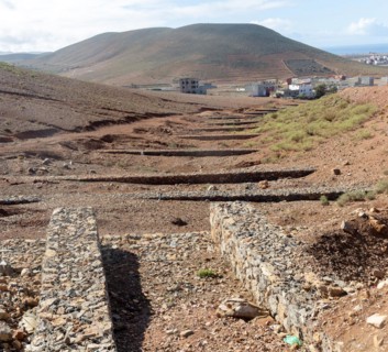Check dams crossing valley to control risk of flash flooding down steep hillside