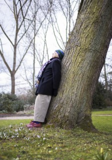 Subject: Pensioner leaning against a tree