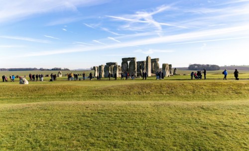 Tourists view standing stones of Neolithic henge