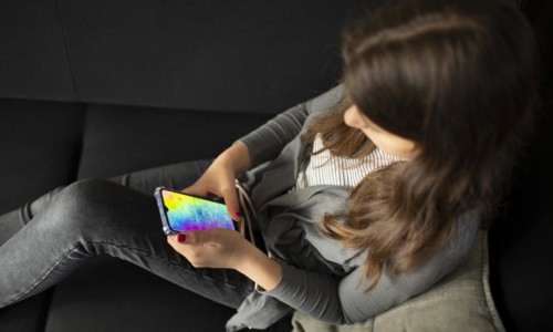 Subject: Teenagers with mobile phones on the sofa