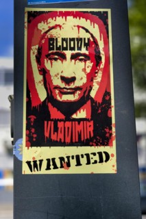 Sticker on a light pole with Putin as Bloody Vladimir who is wanted