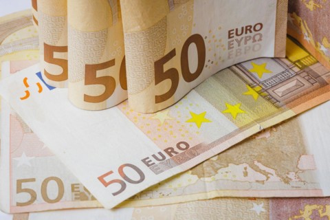 Symbolic photo on the subject of cash. 50 euro banknotes are held in one hand. Berlin
